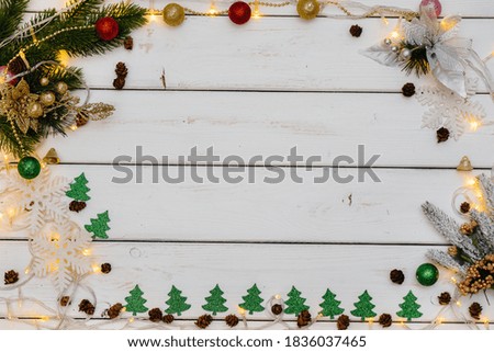White Christmas background decorated with festive decor, lanterns, snowflakes and Christmas tree branches. Christmas greeting card. Winter holiday season. Happy New Year