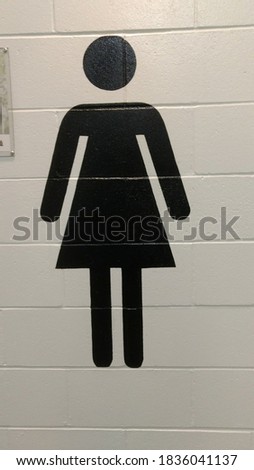 Bathroom black gender signs on brick wall