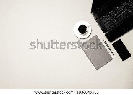 above view for office or home workplace on a gray desk. laptop and another mobile portable devices at workspace.