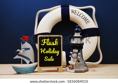 Flash Holiday Sale word on easel wooden board with Marine Decoration Concept