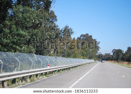 View of the fence that protects animals from being run over by cars on the Pacific highway near Forster, Australia