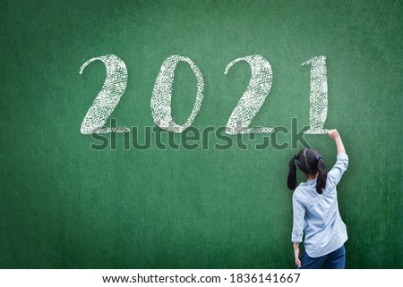 2021 Happy new year school class academic calendar with student kid's hand drawing greeting on teacher's green chalkboard for back to school educational celebration, classroom schedule concept 