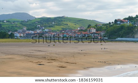Photography of Zumaia in summer day. Bay of Biscay in Basque Autonomous Community / country. The sandy beach of Atlantic ocean. Rare vacationers. High resolution image.