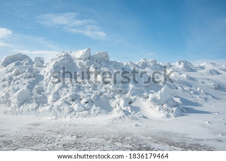 Large piles of snow on the side of the road for cars. High snowdrifts after a snowfall or blizzard Royalty-Free Stock Photo #1836179464