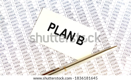On the card text PLAN B, next to the pen. Reports serve as the background.