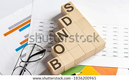 BONDS words with wooden blocks on chart background. Business concept.