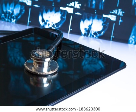 medical stethoscope on modern digital tablet in laboratory on x-ray images background. Concept of health care with new technology