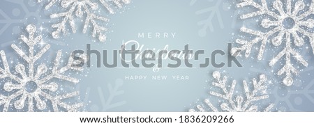Christmas poster with shiny silver snowflakes on a white background. Vector illustration