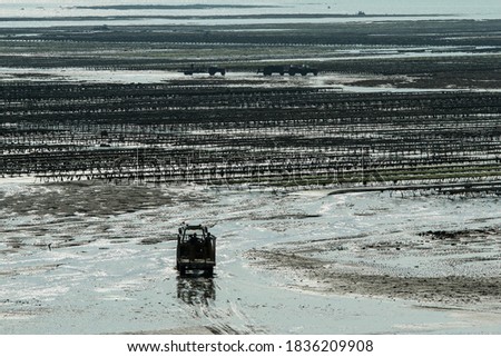 The picture from the oyster farm in Normandy in France at Gouville-sur-Mer during the low tide. 