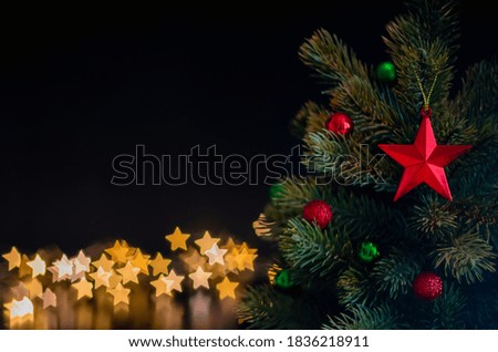 The star ornaments decorate on Christmas tree with star bokeh lights background. Christmas and New year concept.