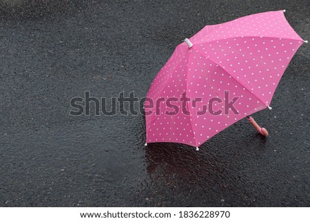 Pink umbrella on a rainy day