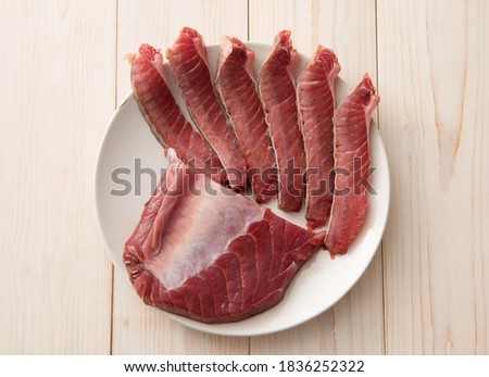 Fresh tuna on plates cut into chunks