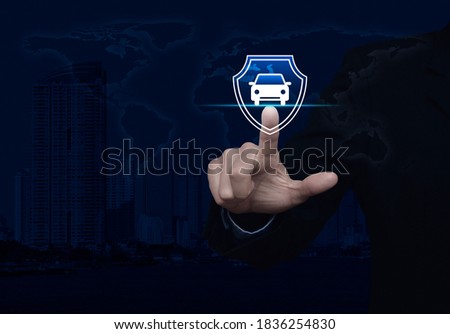 Businessman pressing car with shield flat icon over world map, modern city tower and skyscraper, Business automobile insurance concept, Elements of this image furnished by NASA