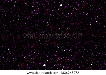 purple bokeh lights defocused on black background. abstract background