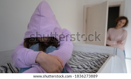 Anxious mom worry about introvert teen daughter hiding in hood, suffer from school discrimination bullying problems. Worried mother distressed with teenage child with psychological mental troubles. Royalty-Free Stock Photo #1836273889