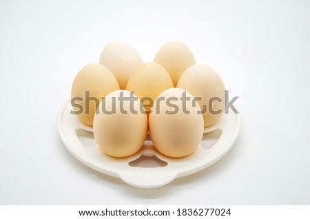 Farm eggs on a white background Royalty-Free Stock Photo #1836277024