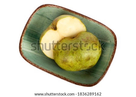 Ripe green pear in the plate