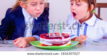 Portrait of happy child girl with cake and candle celebrating birthday. Holiday, happiness, joy and childhood concept. Horizontal image.