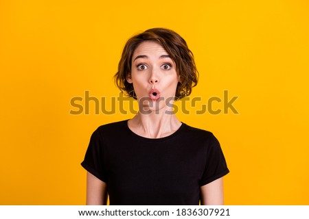 Close-up portrait of attractive wondered girl wearing cotton t-shirt news reaction isolated over vivid yellow color background