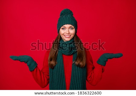 Portrait of her she nice attractive pretty lovely cheerful cheery girl holding on palms copy space choose choice isolated over bright vivid shine vibrant red color background