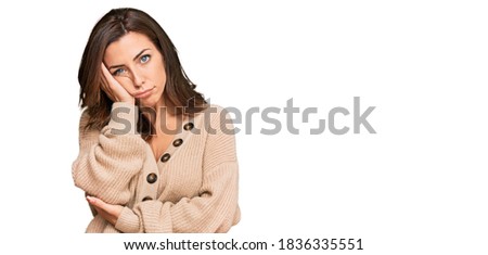 Young brunette woman wearing casual winter sweater thinking looking tired and bored with depression problems with crossed arms. 