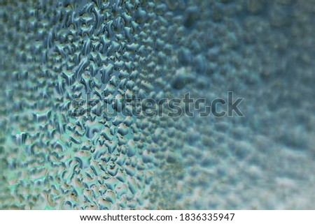 water droplets on glass blue sea wave color - blurred background