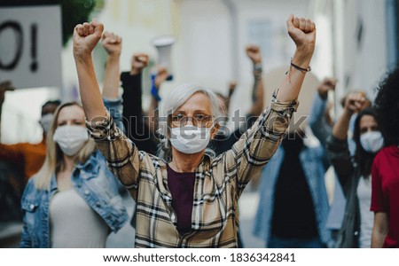 Group of people activists protesting on streets, women march, demonstration and coronavirus concept. Royalty-Free Stock Photo #1836342841