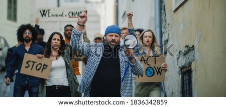 Group of people activists protesting on streets, strike and demonstration concept.
