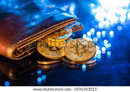 Bitcoin gold coins with wallet, close-up. Virtual cryptocurrency concept. Royalty-Free Stock Photo #1836343015