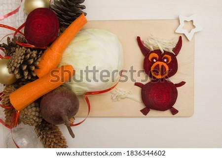 Concept of vegetarian christmas and holiday. Healthy Christmas baby food, creative new year vegetable dish on wooden board symbol 2021. View from above.