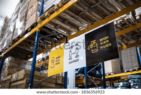 Safety signs on shelves indoors in warehouse, coronavirus concept.