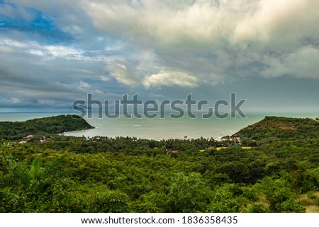 landscape serene view with sea horizon and dense green forests image is taken at om beach gokarna karnataka india from mountain top. it is showing the breathtaking view of gokarna.
