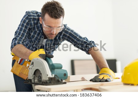 Focus carpenter sawing wood board Royalty-Free Stock Photo #183637406