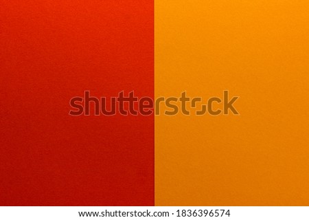 Background of two vertical rectangles red and orange. Sheets of blank red and orange paper with fine texture, split vertically, close up. Royalty-Free Stock Photo #1836396574