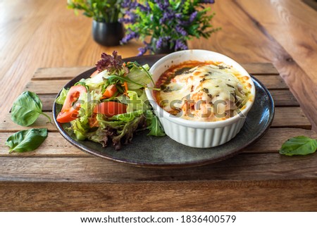 Traditional italian lasagna with vegetables minced meat and cheese On a wooden background