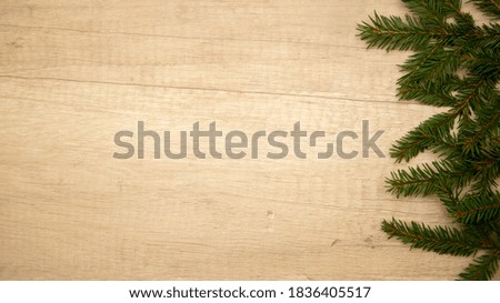 Christmas composition. fir branches on a light wooden background. Frame. Flat lay. Top view and copy space.