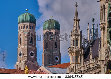 Towers of Frauenkirche church (Cathedral of Our Dear Lady) and detail of the Neues Rathaus (New Town Hall) in Munich, Germany Royalty-Free Stock Photo #1836435565