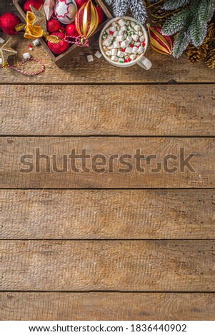 Hot chocolate with marshmallows, warm chocolate drink for Christmas morning breakfast, on wooden background with Christmas decorations, cozy winter pic copy space