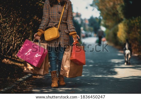 Close up of fashionable teenage girl holding paper bags