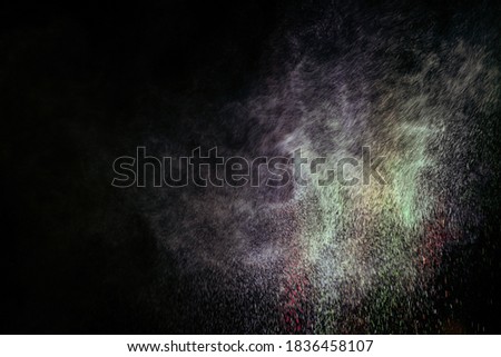 abstract powder splatted background,Freeze motion of color powder exploding/throwing color powder,
 multicolored glitter texture on black background.
