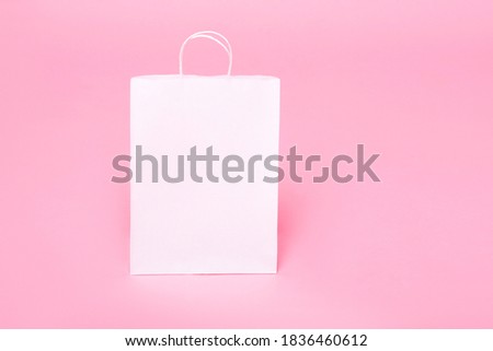 white paper bag for logo on a pink background