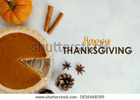 Holiday meal elements with happy thanksgiving text by pumpkin pie background.