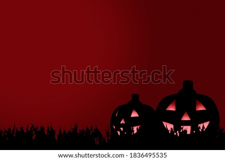 Silhouette of Jack-o-Lantern on the grass with a red background