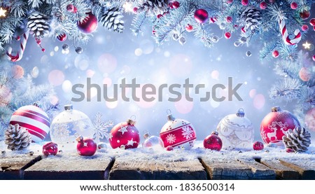 Ornament On Snowy Table With Garland Of Fir Branches - Abstract Christmas Background