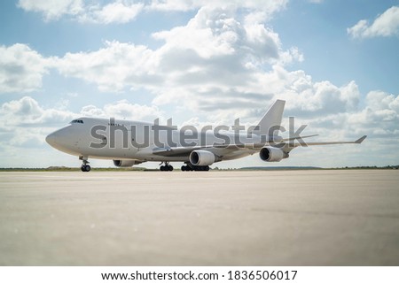 747 in white sat on the tarmac apron ramp ready to taxi Royalty-Free Stock Photo #1836506017