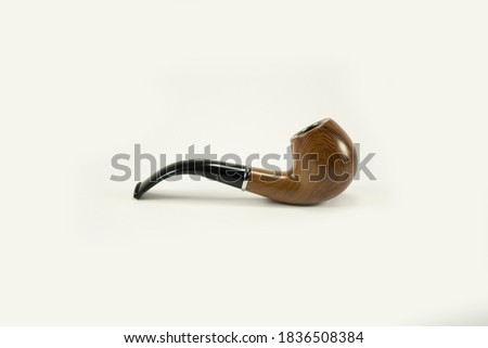 Beautifully patterned tobacco pipe isolated from white background.