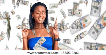Young african american woman wearing casual summer clothes gesturing finger crossed smiling with hope and eyes closed. luck and superstitious concept.
