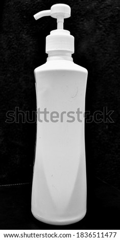 Black and white photography.  Liquid soap container