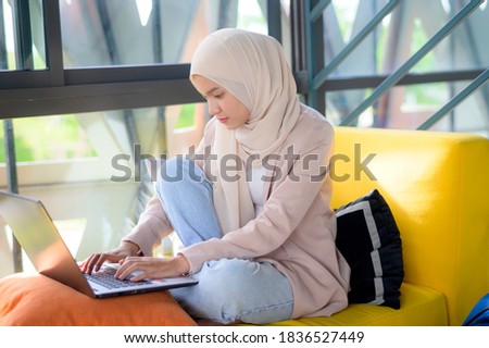 Asian muslim woman working at home.Stop covid-19 coronavirus. New normal lifestyle.