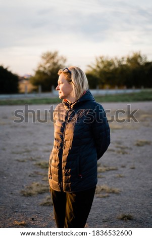 Caucasian woman outdoors traveling in cold weather alone. Vertical portrait candid photo